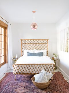 The principal bedroom has deck access and views into the mountains.
