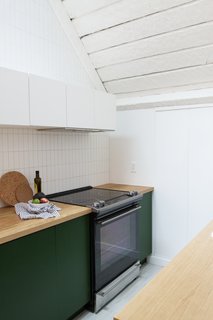 Samuel carried the handmade Fireclay tile up to the ceiling and painted the walls with the Polar Bear shade by Behr.
