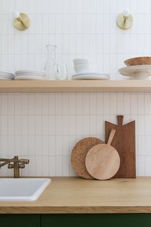 The floating shelf is from Semihandmade, the faucet is from Homary, and the sconces are from Cedar & Moss.
