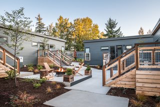 The prefab cabins on site were designed by Seattle–based architecture firm SHW, manufactured in Idaho, and installed by local contractors from Cascade Built. Here, a shared courtyard features a fire pit.