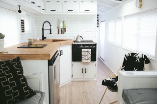 For the L-shaped kitchen, the family chose an under-counter fridge/freezer unit in order to have more counter space. The 23-inch Vigo sink is deep enough to bathe a baby, or hide dirty dishes.