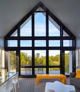 This large screened porch is a favorite destination of the homeowner. "She spends a lot of time on the screened porch because it straddles the meadow and the mountains," said Wiedemann. "And it's directly accessible from the living area and the kitchen."