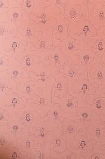 An up-close view at the detail of the wallpaper drawn with portraits of famous female leaders.