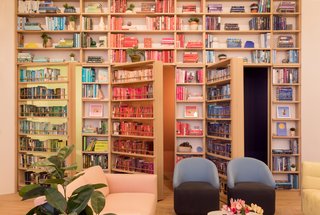 Secret doors in the bookcases conceal soundproof phone booths.