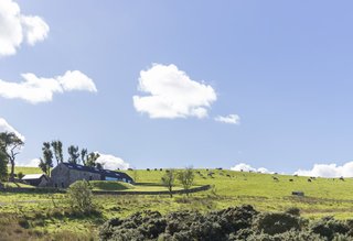 The renovated home is nestled in its country setting with distant views into two valleys.