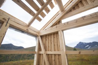 In the garage, wooden joints are exposed, and the peak of Ryssdalsnebba can be seen to the south.