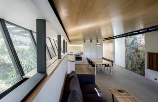 An Arresting Australian Abode by Glenn Murcutt Needs a Buyer - Photo 8 of 8 - Part of the design brief was to integrate this vibrant tapestry, titled Orion M.C., by Victor Vasarely. "The work of art is naturally lit by the white opal glass roof lights and is viewed through a glass wall from the dining room into the stair well," Murcutt says.