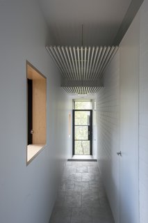An Arresting Australian Abode by Glenn Murcutt Needs a Buyer - Photo 4 of 8 - Passageways take advantage of the southern side of the house, so that living areas and bedrooms receive northern sunlight. White walls are satin-finished or bagged brickwork.
