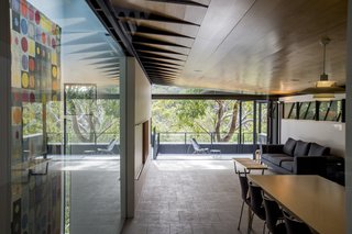 An Arresting Australian Abode by Glenn Murcutt Needs a Buyer - Photo 5 of 8 - The open-plan living area, complete with sealed concrete floors and ceilings lined with hoop pine, looks out on a 366-square-foot veranda and has views towards the natural estuary of Pittwater.