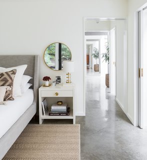 A 1957 Midcentury in Seattle Receives a Striking Makeover - Photo 8 of 16 - The architects have also created a suite by connecting an adjacent bathroom via pocket doors. The skylight in the bathroom ensures that natural light flows throughout.
