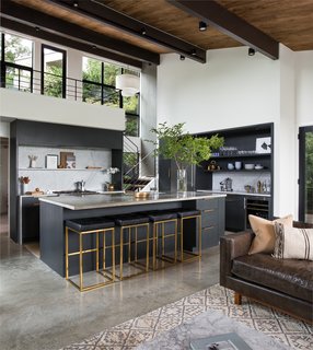 A 1957 Midcentury in Seattle Receives a Striking Makeover - Photo 3 of 16 - The entry connects to the open kitchen and living space. Although the second-floor mezzanine was once enclosed, the architects have removed the walls, bringing in more light and a better connection to the outdoors.