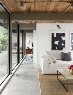 A 1957 Midcentury in Seattle Receives a Striking Makeover - Photo 7 of 16 - In the family room, "short ribbon windows were replaced with a wall of glass" for a effortless indoor/outdoor flow.
