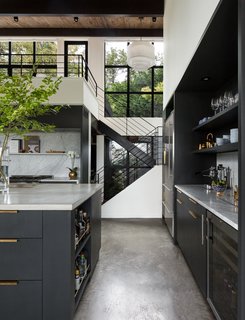A 1957 Midcentury in Seattle Receives a Striking Makeover - Photo 4 of 16 - Here is a look back toward the stairwell and entryway. The wood ceiling adds warmth to the black and white scheme.