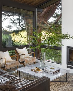 A 1957 Midcentury in Seattle Receives a Striking Makeover - Photo 6 of 16 - While the window openings in this cozy corner are the same as before, the architects tweaked the frames. "The layout of the windows was flipped so that the horizontal division was rail height, rather than obstructing sight-lines when standing," the team explains.