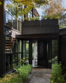 A 1957 Midcentury in Seattle Receives a Striking Makeover - Photo 1 of 16 - The exterior's updated siding and new windows help to create a cohesive look.