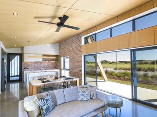 The home's rectilinear floor plan facilitates coastal cross-breezes (or passive cooling), while thermally broken double-glazed windows ensure the building envelope stays tight to reduce carbon emissions.