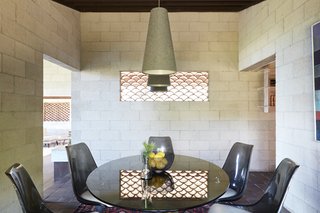 Light and air transmits through the wall cut-out in the dining room.