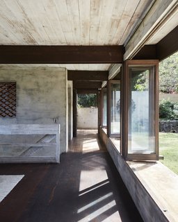 Folding doors line the courtyard. Cinder block walls are coated in stucco made with sand from the community of Waimānalo, and mixed with concrete and water.
