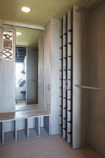 A dressing room boasts clever, built-in storage.