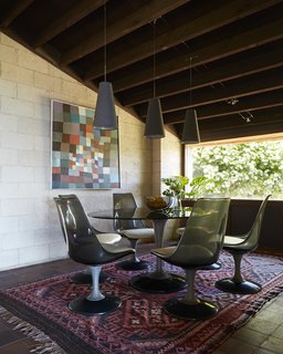 Exposed wood ceilings and tile floor outfit the dining room.