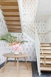 Custom wallpaper made by Joana Avillez and Payton Turner offers whimsical illustrations of significant historical female figures who worked for social change.