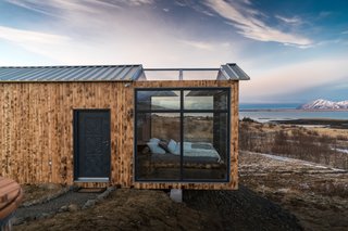 The cabin is located in Hvalfjörður, Iceland, just a 30-minute drive from Reykjavík, and can only be accessed by car. The area is remote, private, and quiet, making it ideal for viewing the Northern Lights at night, as well as hiking during the day.