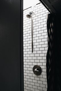 The couple improved the shower before moving back on the bus full-time by enlarging its size so they don't have to crouch under the shower head. "Before we moved back into the bus, we decided to lift the roof and build a proper shower," Ashley states. "We enlisted our best friend (@nomadicmillers) and he and Brandon worked to come up with the perfect solution: a 14" lift with a custom skylight, a step, and subway tile. It’s now our very own spa-shower in a bus. It took about three weeks to complete and about $1000, but has been worth every penny."