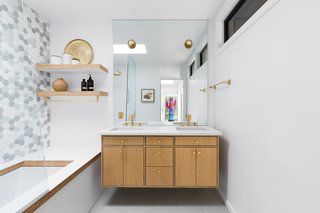 The vanity, shelving, and tub surround are all custom. They're fabricated from marine-grade, hardwood ply that has been treated with multiple layers of sealer. For the tub surround and shelves, there's an additional layer of Formica veneer.
