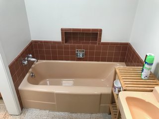 A Jack-and-Jill bathroom with worn fixtures and finishes was tweaked so that it solely connects to the principal bedroom and forms a private suite.