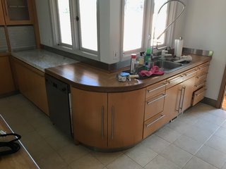 Many of the original kitchen cabinets were kept in place, including this curved corner cabinet, as all were beautifully made, and the owners loved them, says Horner.