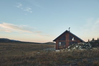 The couple wanted their cabin to mesh with its beautiful natural surroundings. "To us, this meant small," says Kenny. "We wanted the design to put you right into the landscape, and by making it small we feel drawn to the night sky and mountains that surround us."