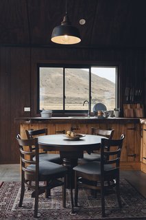 The interior walls are Ecoline V groove ply. "I chose to use a dark-colored stain inside, so that the walls almost disappear and you’re drawn through the windows to the outdoors," says Kenny.