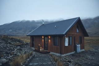 The exterior siding is in a traditional board and batten style, then accented with a steel roof.