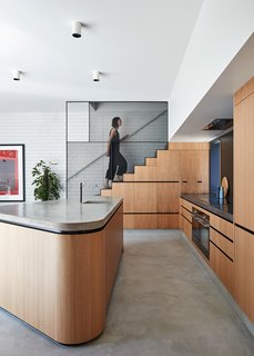 A steel mesh balustrade lines the stairway, which leads to the rooftop deck.