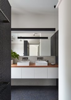 In the bathroom, the color scheme for the penny tiles reflects the exterior palette for continuity.
