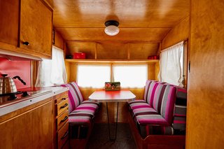 The bright, custom upholstery in this banquette mixes beautifully with the otherwise neutral color scheme.