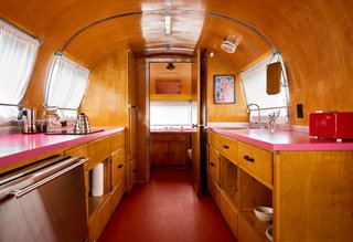 This trailer features hot-pink laminate countertops, which work nicely with the surrounding woodwork.