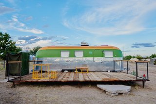 Custom outdoor furniture sits on the decks of each trailer.