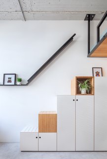 The staircase leading to the bed also functions as a large wardrobe.