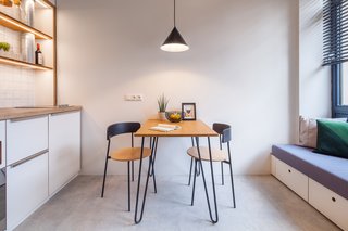 Freestanding furniture with thin metal legs doesn't clutter the small space.