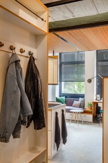 Tidy closet storage frames the entry to the apartment.
