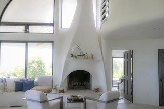 The lines of the fireplace column echo the exterior geometry.