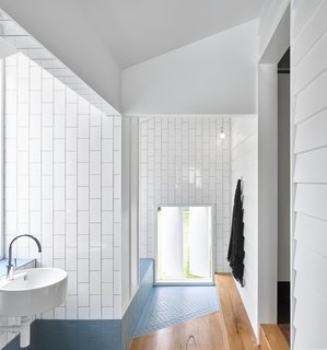 The angled tile floor-pad designates the entrance to the bathtub area.