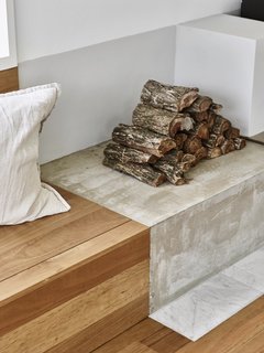 A close-up detail of the striking material connection between timber and concrete.