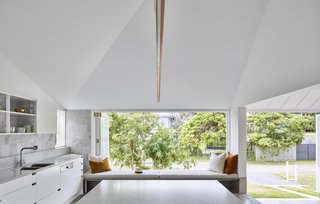 The kitchen window-seat overlooks the backyard garden.