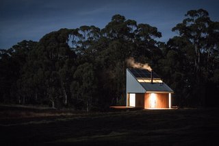 "Translucent glass in the sliding doors references the light qualities of Japanese rice-paper screens, creating a sense of enclosure and privacy at night, while encouraging the occupant to open them during the day," explain the architects. "They also prevent birds, including the endangered swift parrot, from attempting to fly through the building and striking the glass."