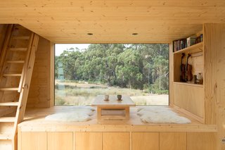 "The views to the north are unsettling, with tall, dense forest always in dark shadow," notes the architects. For that reason, they positioned the cabin so this serene seating area would take advantage of the southern view, which is more expansive.
