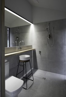 The interior bathroom can do double-duty as a mudroom, thanks to a secret door that enables exterior access. Additionally, that door delivers an "almost" outdoor showering experience, and has been designed so guests can use the restroom without disturbing others sleeping inside.