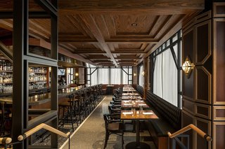 A rosewood coffered ceiling, swanky black banquette, black granite bar, and intricate millwork greet you at Q.