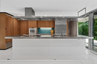 The kitchen was appropriately modernized with white lacquer and stainless steel.